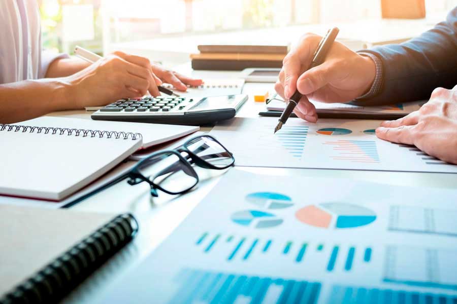 A person checking graphs of his company's financial costs.