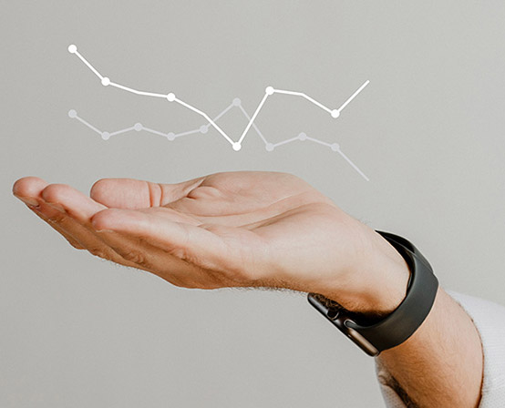 A hand indicating data analysis graphics.