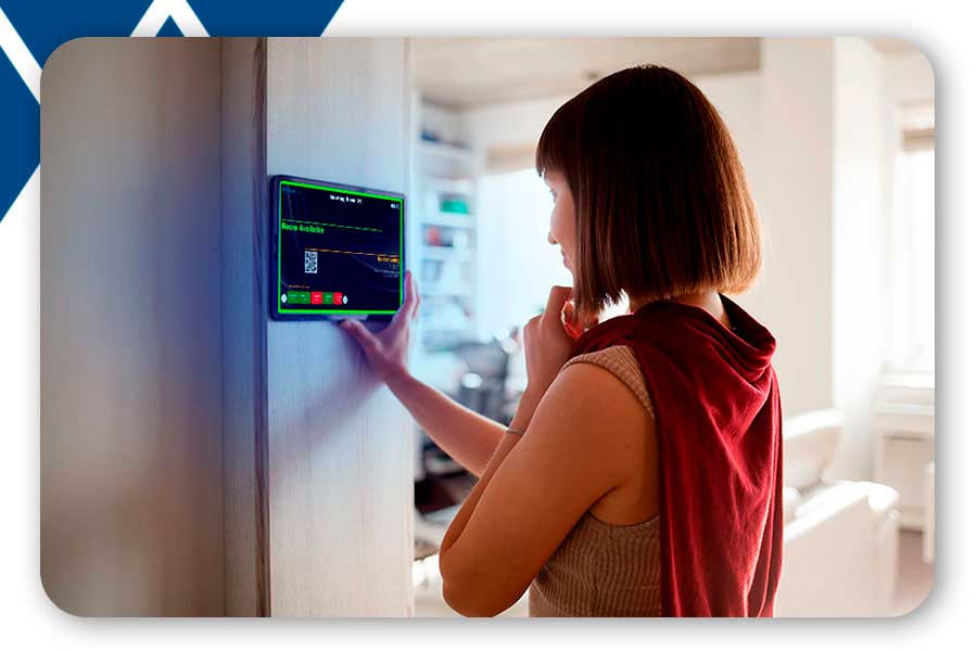 A woman using the Neptune booking display in front of a meeting room.